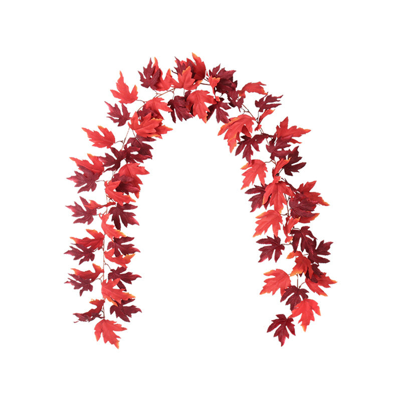 A garland of vibrant red and orange maple leaves arranged in an arch shape on a white background.