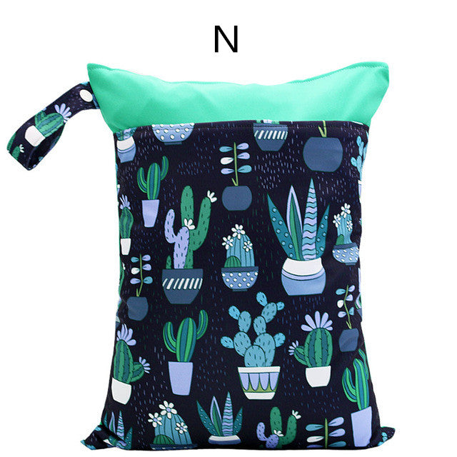 Colorful bag with a green top and handle, featuring a pattern of various cacti and potted plants on a dark background. A letter "N" is printed above.