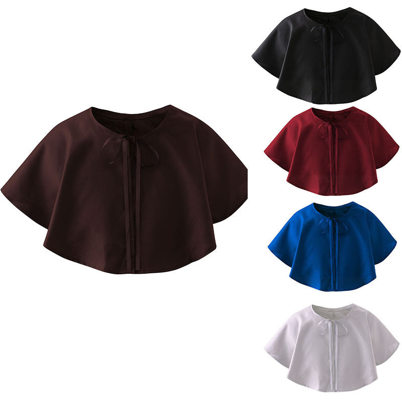 Five short capelets in black, brown, red, blue, and white are shown. They are tied at the neckline with a ribbon, featuring a simple design and compatible with various outfits.