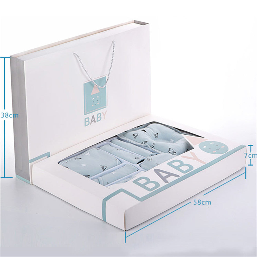 Open gift box with pastel blue baby clothing featuring small black designs. Box labeled "BABY" with dimensions: 58cm wide, 38cm tall, 7cm deep, with handles.