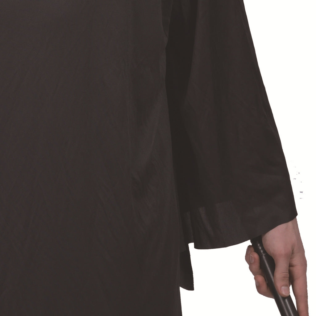 A person in a black robe holds a cane with their right hand. The focus is on the hand and cane, with the black fabric draping down smoothly on the side.