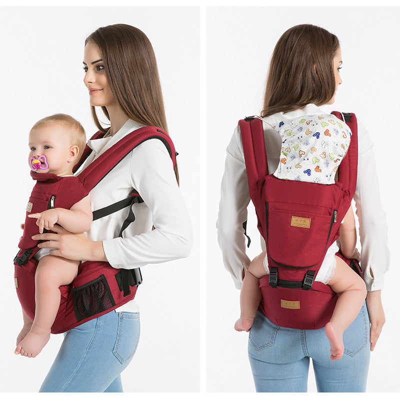 A woman in a white top carries a baby in a red baby carrier, showing front and back views. The baby has a pacifier and both seem comfortable and secure.