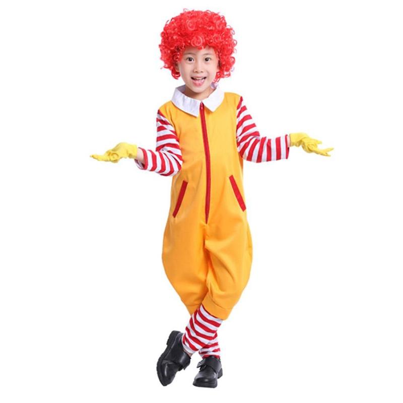 Child dressed in a clown costume with a red curly wig, yellow jumpsuit, red and white striped sleeves and leggings, yellow gloves, and black shoes, arms outstretched.