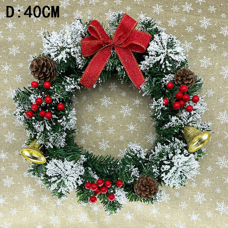 Festive holiday wreath with a red bow, pinecones, red berries, gold bells, and snow-dusted greenery. Diameter: 40cm. Background features a beige snowflake pattern.