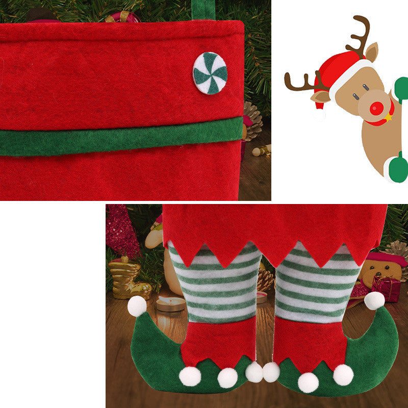 Close-up of a red felt stocking with a peppermint button and green trim, alongside illustrated festive designs. Below, elf-like legs wear striped socks and curled shoes with pom-poms.