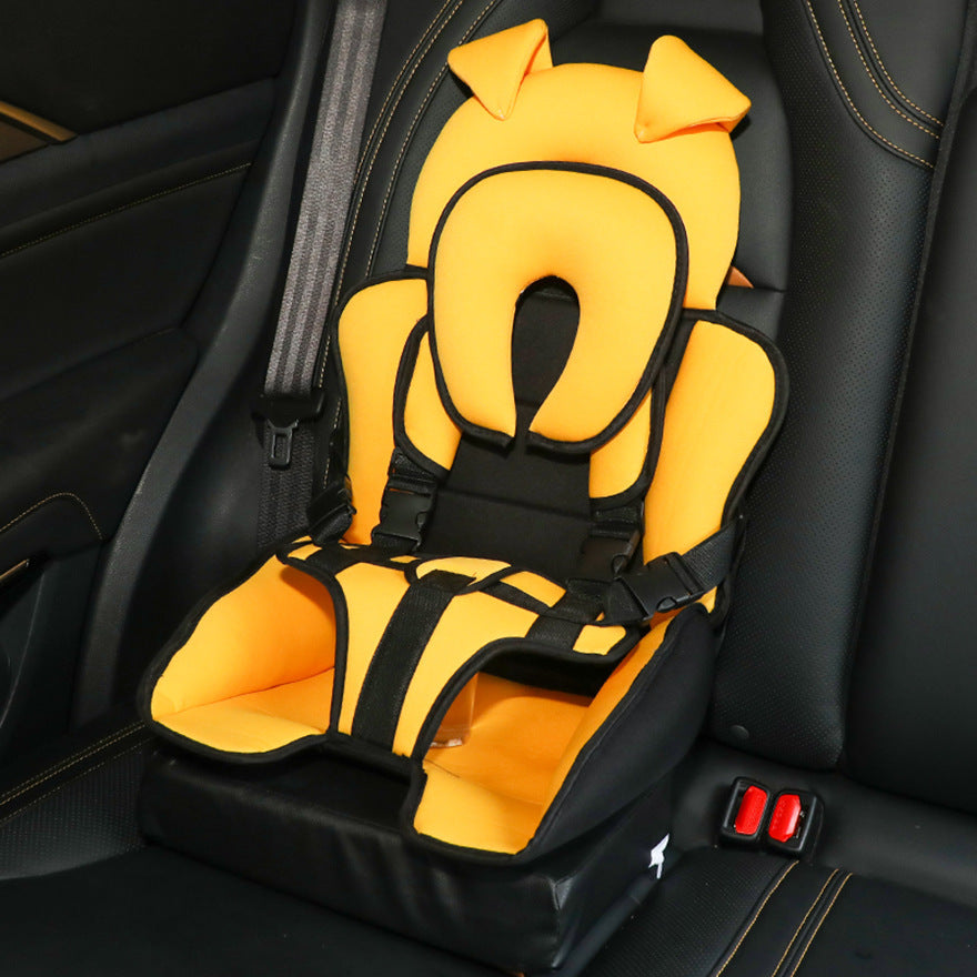 A bright orange and black children's car seat with ear-like features on the headrest is securely strapped in a car's backseat, showcasing safety harnesses and padding.