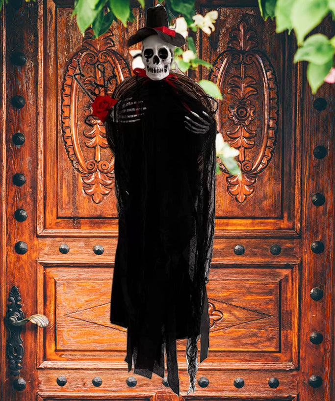 A skeleton figure in a black cloak and wide-brimmed hat stands in front of an ornate wooden door with intricate patterns. It holds a red rose in one skeletal hand. Green leaves and white flowers frame the top of the image, adding contrast to the scene.