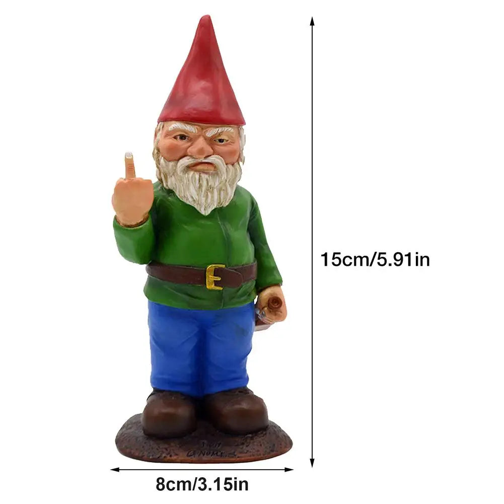 Garden gnome statue with a red hat, green shirt, and blue pants, making a rude gesture. It measures 15 cm tall and 8 cm wide on a brown base.