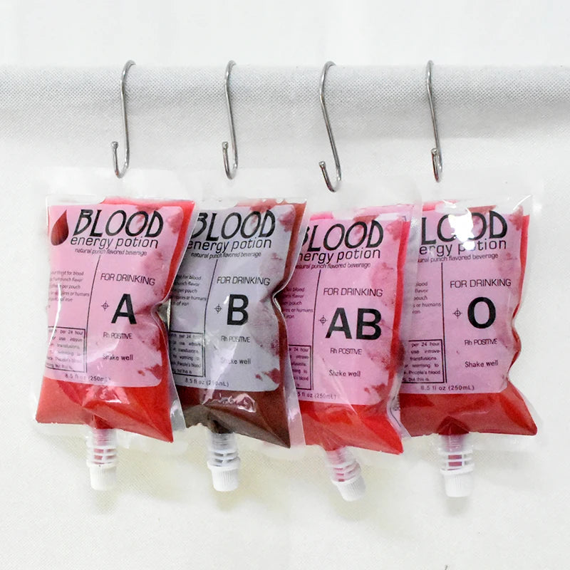 Four blood type-themed energy drink pouches labeled A, B, AB, and O hang from hooks. The packaging resembles blood bags, with red-colored liquid inside.