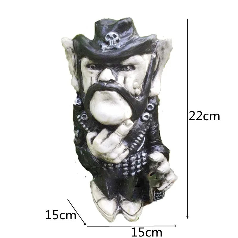 Statue of a stern-faced figure with a cowboy hat and mustache, wearing a studded jacket. It shows a gesture with its hand. Dimensions are 22cm tall and 15cm wide.