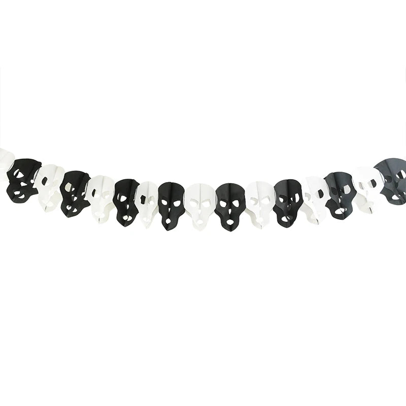 A garland of alternating black and white paper skulls hangs against a white background. Each skull features cut-out eye and nose holes, creating a festive and spooky decoration ideal for Halloween. The arrangement forms a color pattern with skulls facing frontward in a continuous line.