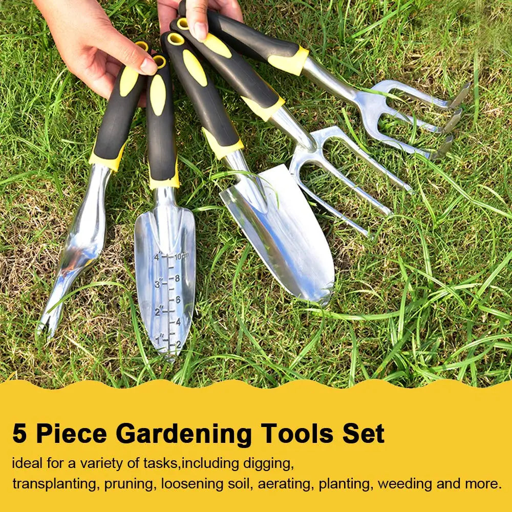 Five-piece gardening tool set on grass includes a trowel, transplanter, weeder, hand rake, and cultivator. Tools have black and yellow handles, ideal for various gardening tasks.