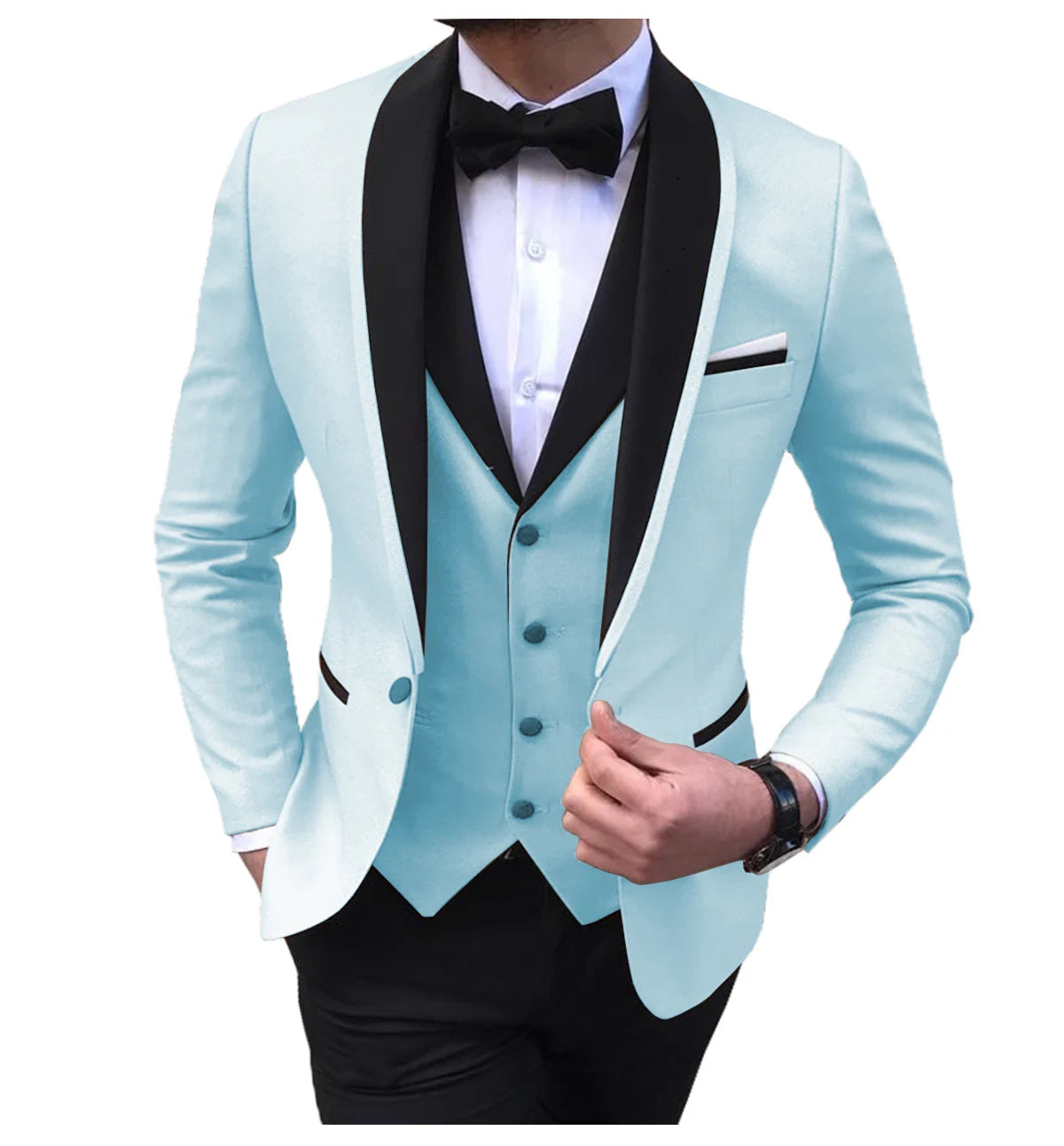 Man in a stylish light blue tuxedo with black shawl lapels, white dress shirt, and black bow tie. The vest matches the tuxedo, and he wears a wristwatch.