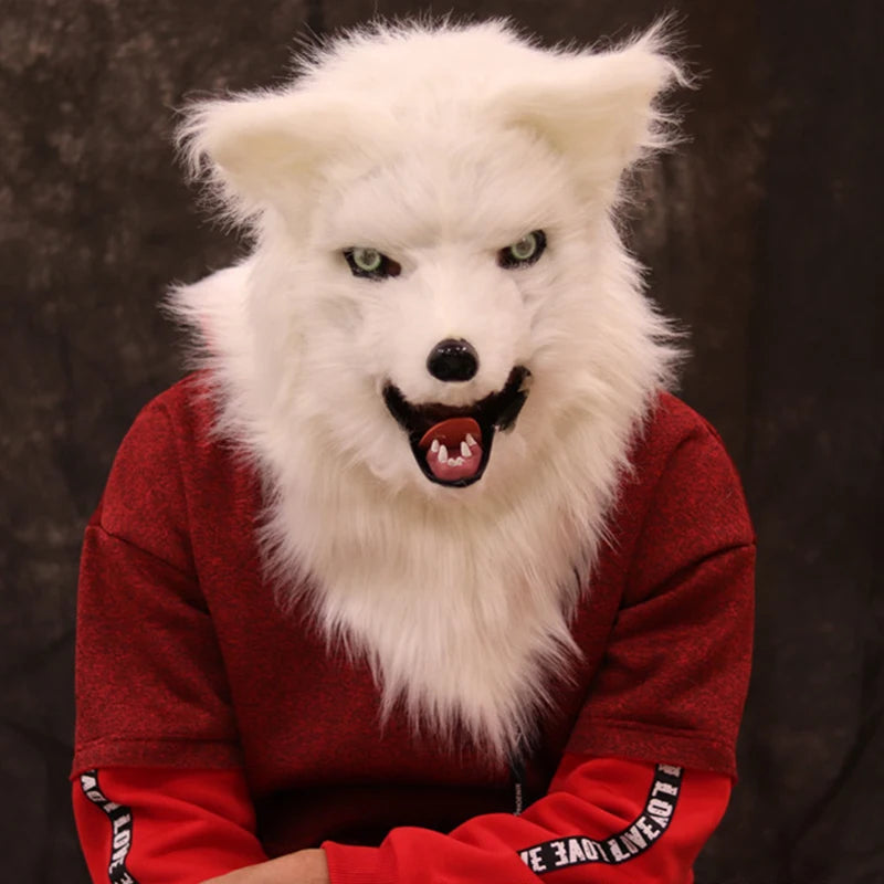 Person in a red sweatshirt wearing a white wolf mask with realistic fur and snarling expression, sitting against a dark background.