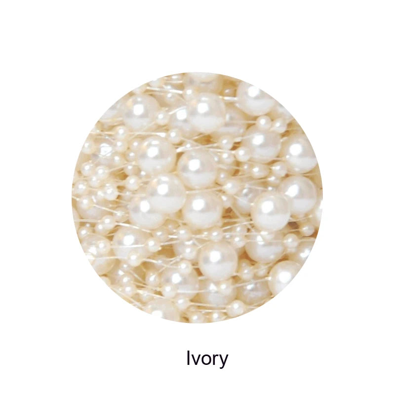 Close-up of assorted ivory pearls of different sizes, creating a clustered, textured appearance. The word "Ivory" is written below the circular frame containing the pearls.