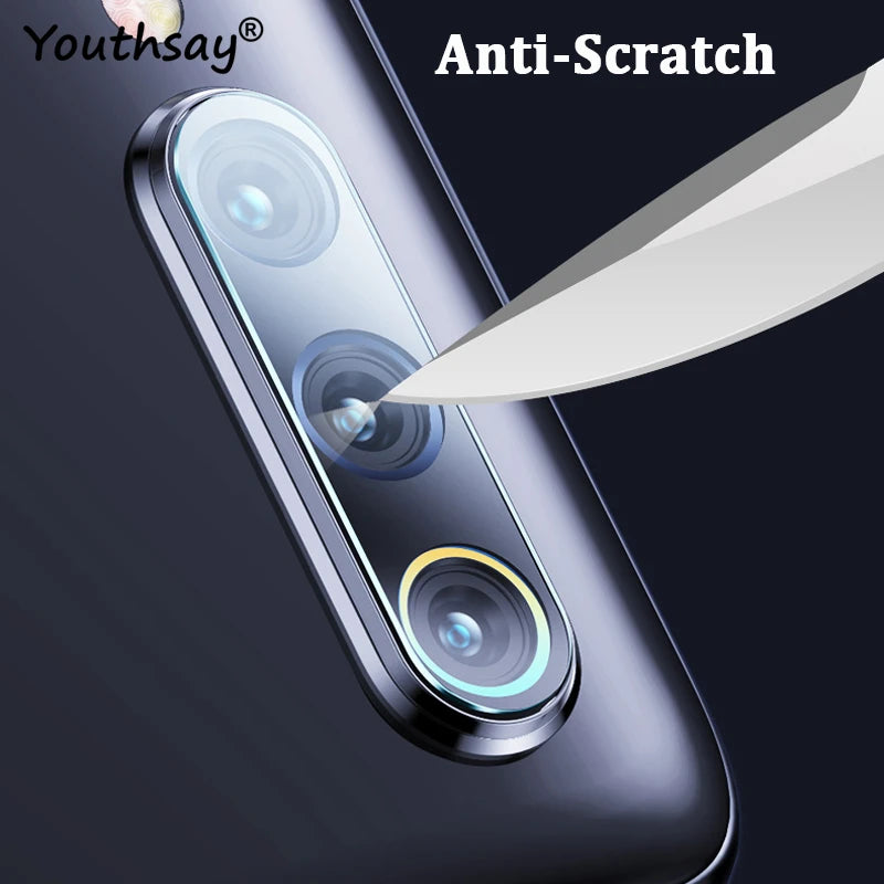 Close-up of a smartphone's camera lens being scratched by a knife, showcasing the anti-scratch feature. Text reads "Anti-Scratch" and "Youthsay" on a dark background.