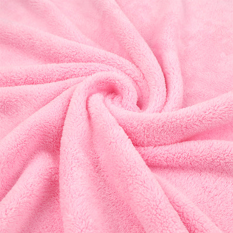 Soft pink fleece fabric in a spiral pattern, showcasing its plush texture and gentle folds.