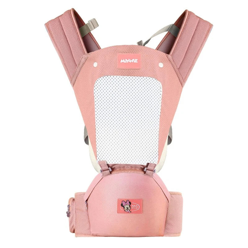 Pink baby carrier with padded shoulder straps and a breathable mesh panel. It features a cartoon character logo on the front pocket.