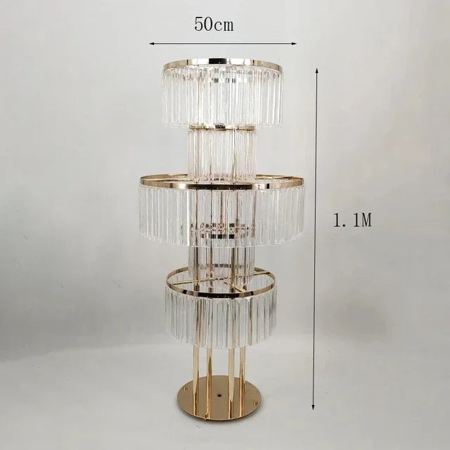 Elegant floor lamp with three tiers of crystal-like prisms, golden structure. Measures 1.1 meters in height and 50 centimeters in diameter.