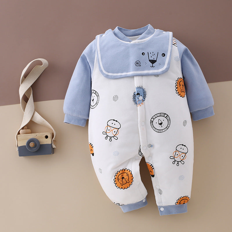 Baby jumpsuit with blue sleeves and animal prints, featuring lions and cartoon characters. A fabric camera toy with a beige strap is placed beside it on a brown background.