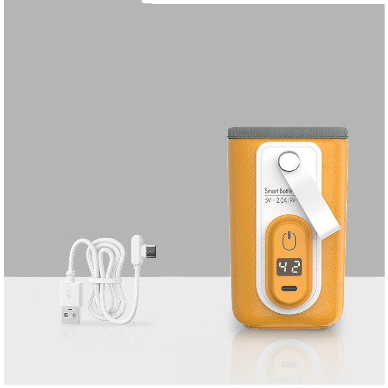Portable orange smart bottle warmer with a digital display showing 42°C. It features a gray lid, a power button, and comes with a white USB charging cable.