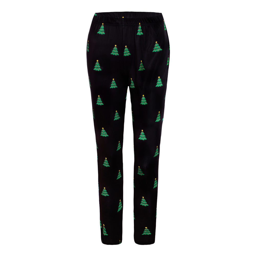 Black pajama pants with a festive pattern of green Christmas trees, each topped with a yellow star, evenly distributed across the fabric.