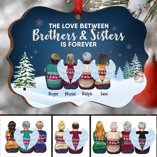 A festive ornament shows four figures wearing angel wings and Christmas sweaters, sitting with backs turned. Text above reads, "The love between brothers & sisters is forever."