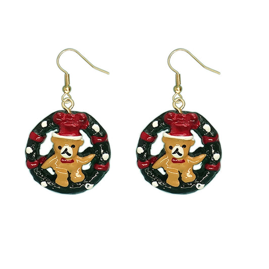 Festive earrings featuring teddy bears with red hats inside green and red wreaths decorated with white dots, hanging from gold hooks.