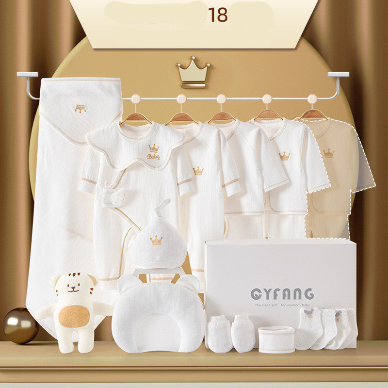 Baby clothing set in white, featuring onesies with crown emblems, plush bear toy, socks, a pillow, and a gift box labeled "CYFANG." Displayed on a gold background.