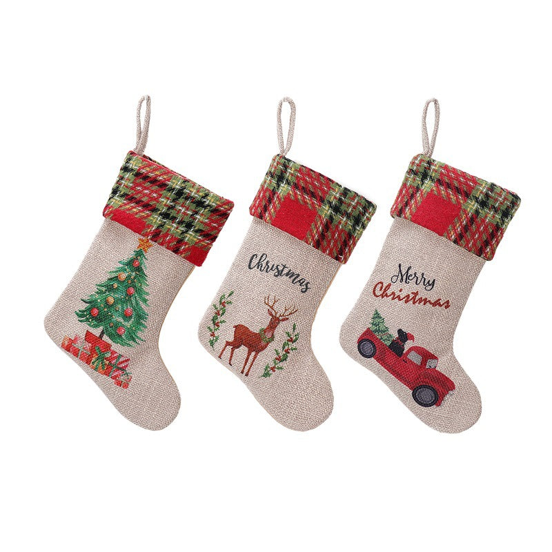 Three Christmas stockings with plaid tops. Designs: a tree with gifts, a reindeer with holly, and a red truck with a tree. Texts: "Christmas" and "Merry Christmas."