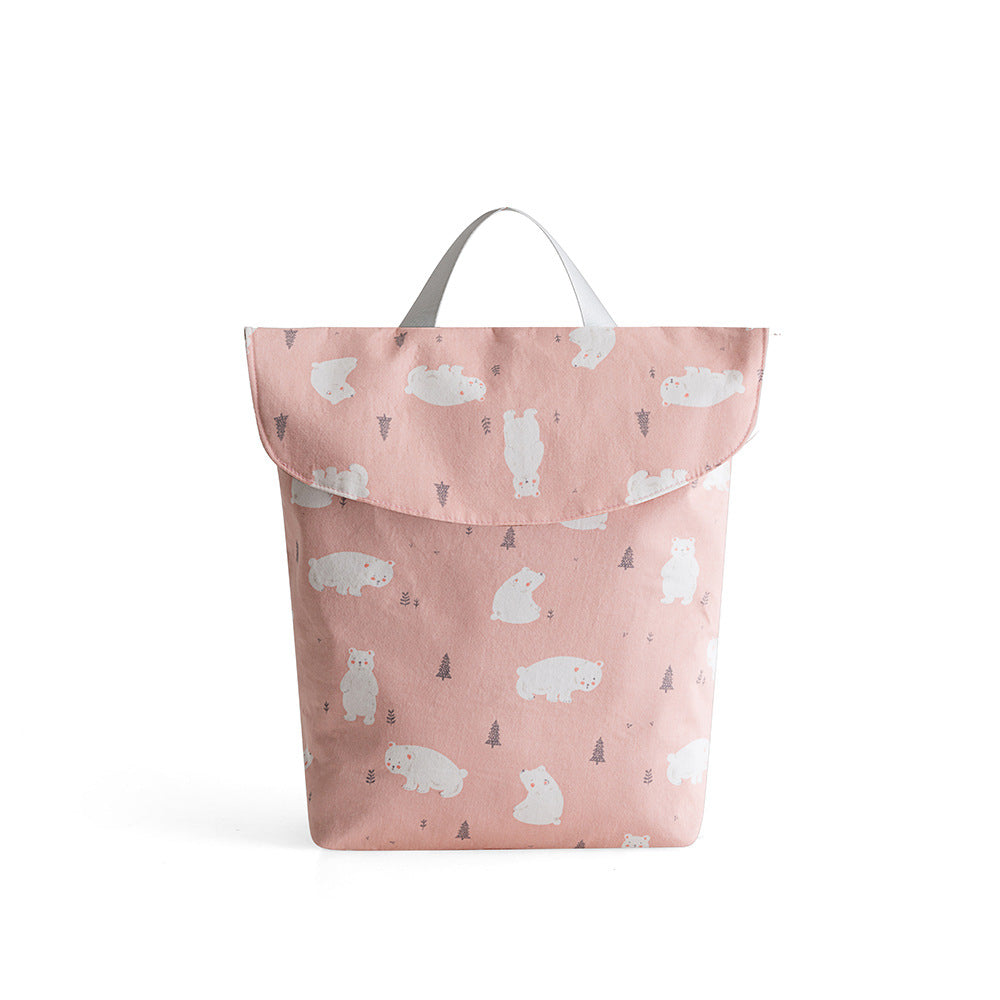 Pink backpack with a playful polar bear pattern and small trees. It features a simple handle, flap closure, and a soft, cute design ideal for casual use or as a kid's bag.