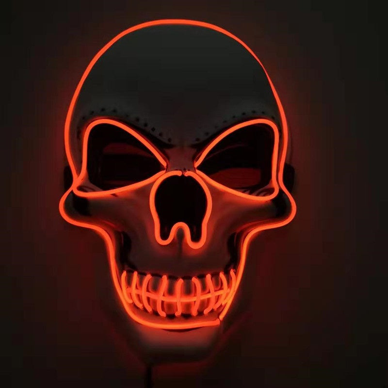 Glowing neon skull sign with red outline on a dark background, featuring hollow eyes and bared teeth.