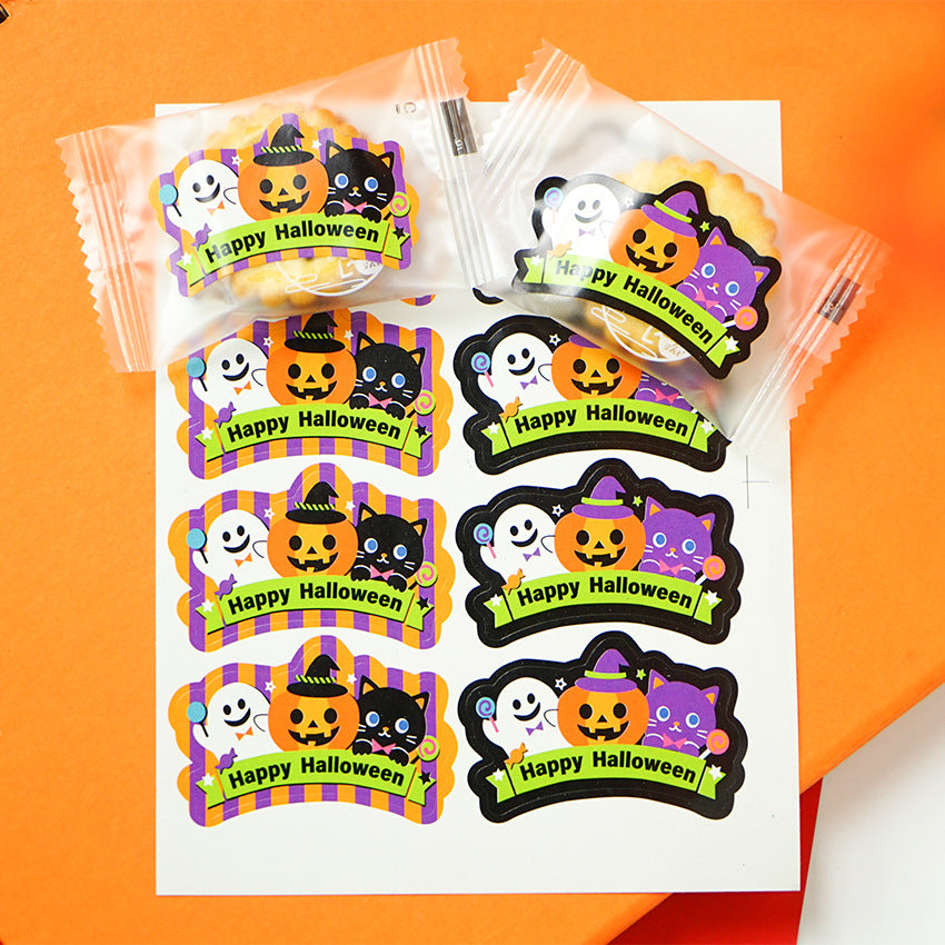 Halloween-themed stickers and packaged sweets are displayed on an orange background. The stickers feature a jack-o'-lantern, ghost, and a black or purple cat with "Happy Halloween" on a green banner. The treats are individually wrapped with similar festive designs.