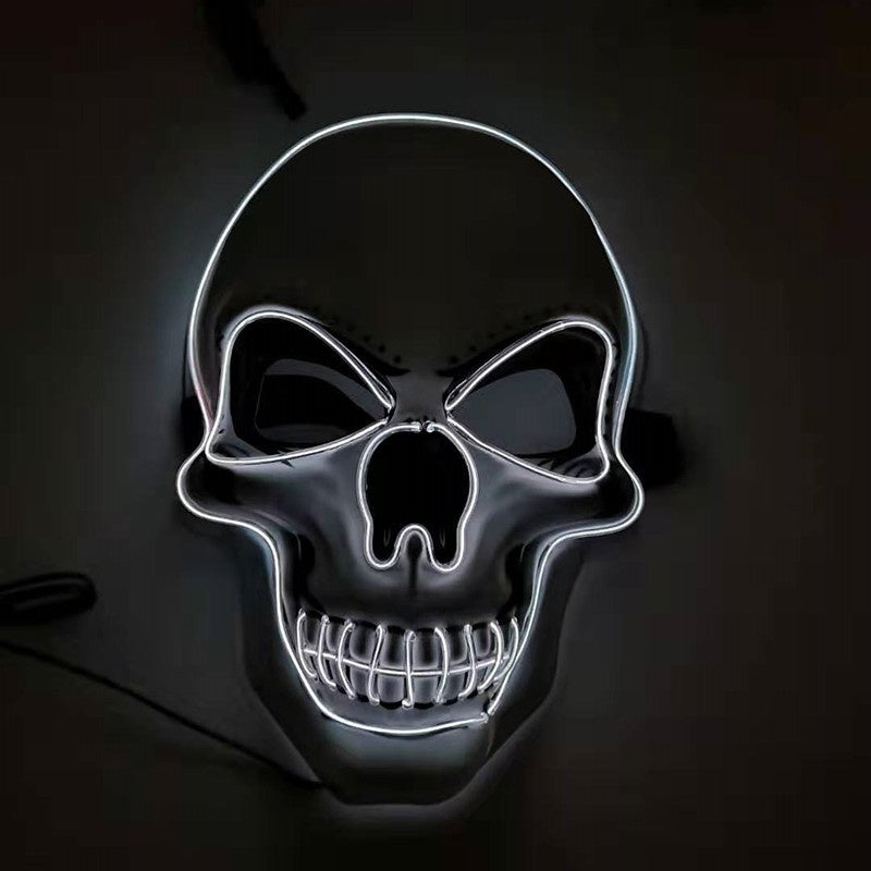 Glowing neon skull with dark eye sockets and wide grinning teeth, outlined in white light against a dark background, creating an eerie and striking visual.