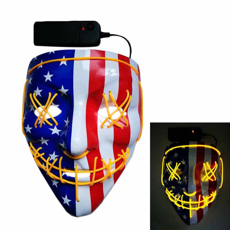 LED mask with American flag design, featuring yellow stitched eyes and smile. The inset shows the mask glowing in the dark, powered by a connected battery pack.