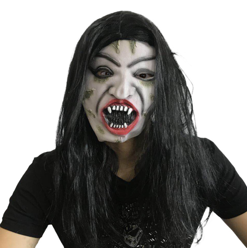 Person wearing a spooky vampire mask with wild black hair, pointed teeth, and grey patches on pale skin, dressed in a black shirt, glaring intensely at the camera.