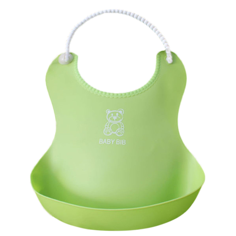 Green silicone baby bib with a bear design and "BABY BIB" text, featuring a scoop bottom for catching food. A white, flexible neck strap secures the bib.