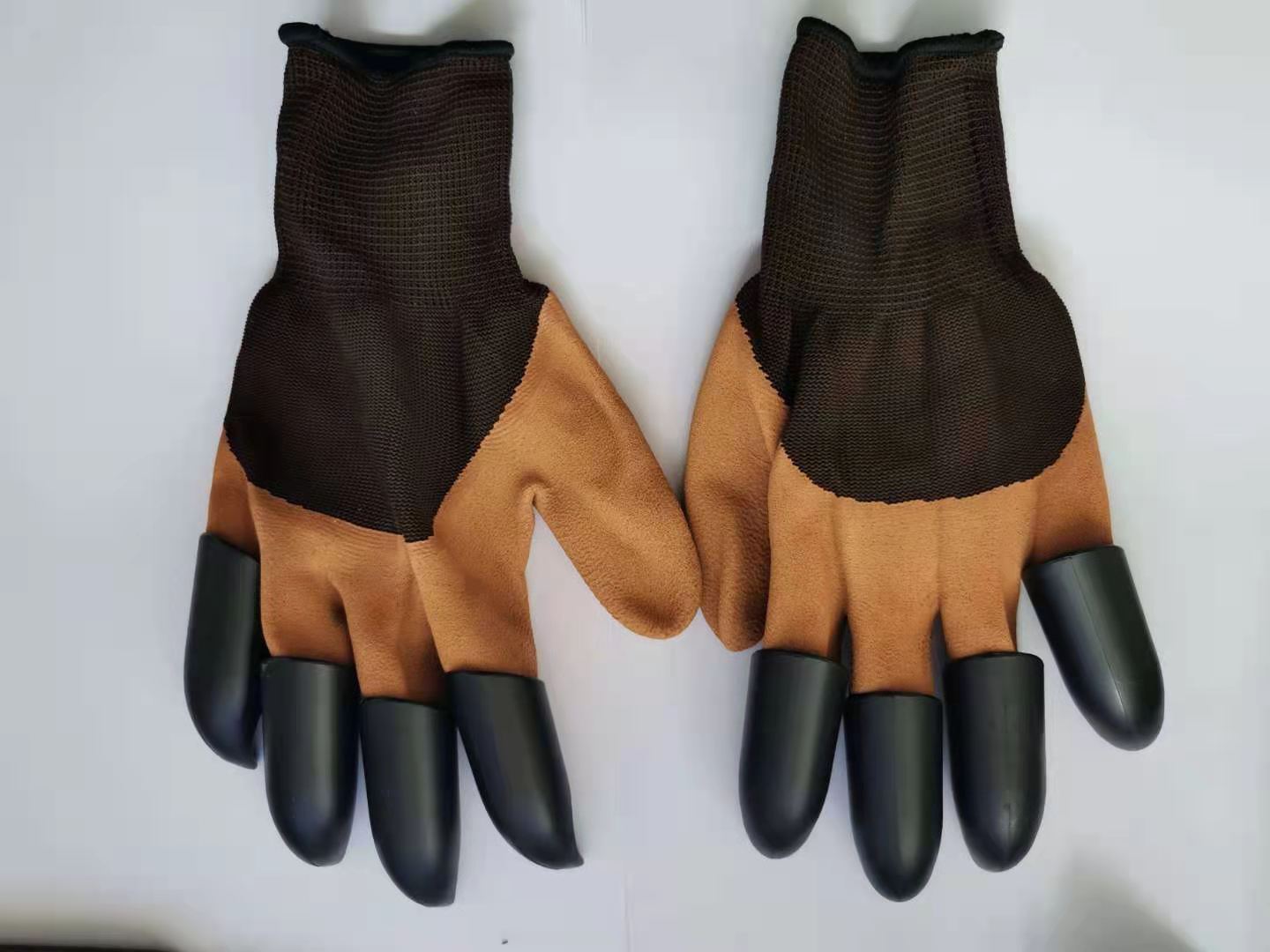 Two gardening gloves with brown fabric and black rubber fingertips, featuring mesh cuffs, are laid flat against a plain white background.
