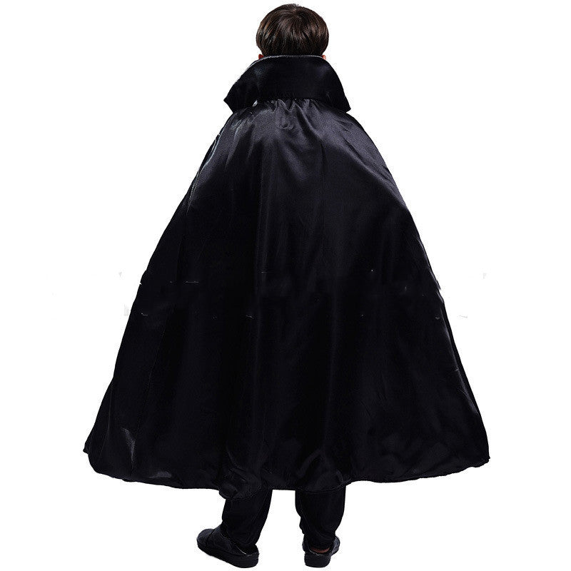 Rear view of a person wearing a long, flowing black cape with a high collar, standing against a plain white background.