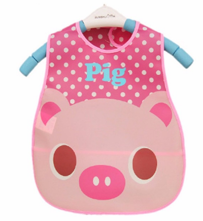 Pink waterproof bib with a pig face design, white polka dots on top, and "Pig" written in blue. It's hanging on a white hanger with blue shoulder grips.