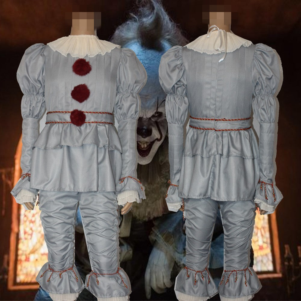 Two faceless mannequins display classic clown costumes with ruffled collars, red pom-poms, and puffy sleeves. A menacing clown face is visible in the dark background.