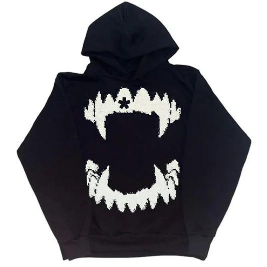 Black hoodie featuring a large white graphic of jagged teeth on the front. The design consists of an angular upper and lower set of teeth, framed by abstract shapes, giving a bold, striking appearance. The hood and sleeves are solid black, complementing the bold graphic.