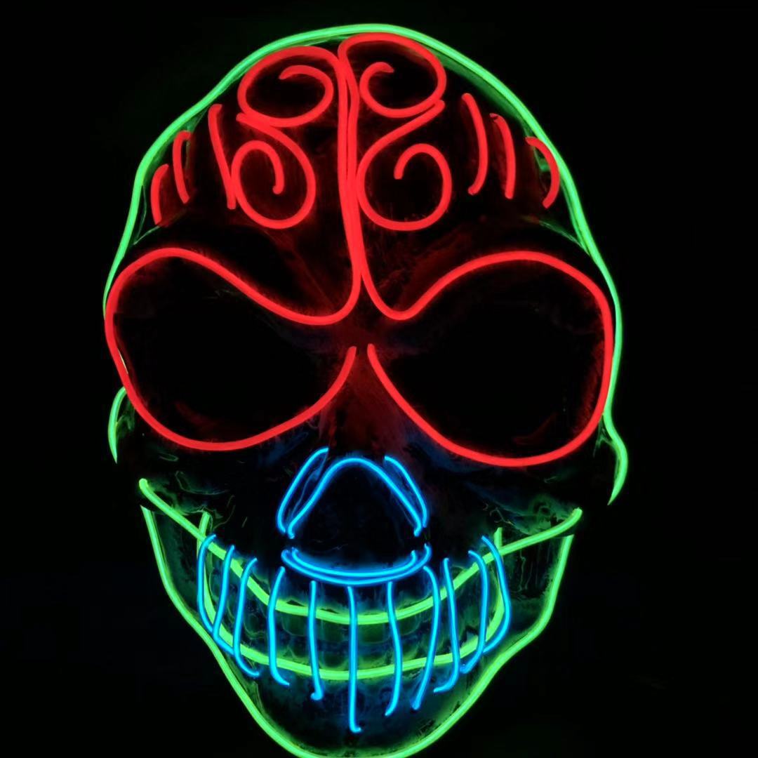 Neon skull art with intricate red, green, and blue designs. Red swirls on top, green outline, and blue teeth, creating a vibrant, glowing effect on a black background.
