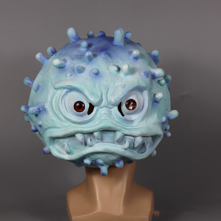 A blue and purple monster mask features menacing red eyes, sharp teeth, and protruding spikes, displayed on a mannequin head against a plain grey background.