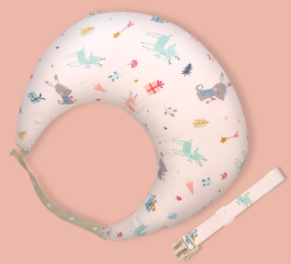 Cute baby nursing pillow with playful, colorful animal and gift prints on a soft pink background, featuring a detachable beige strap.