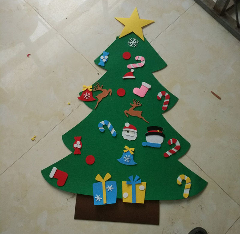 Felt Christmas tree on a tiled floor, decorated with a yellow star, reindeer, candy canes, Santa, snowman, stockings, ornaments, and presents in various colors.