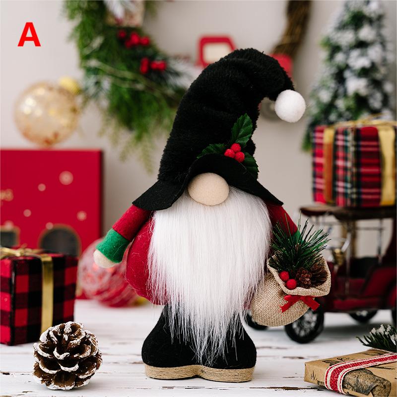 A festive gnome figurine with a black hat and white beard holds a small sack of pine sprigs. Surrounded by wrapped gifts and a pine cone on a holiday-themed backdrop.