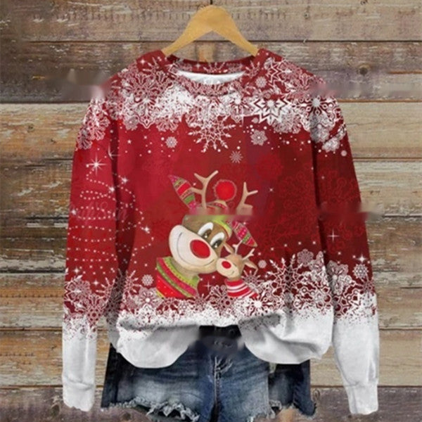Red Christmas sweater with a cheerful reindeer design, adorned with white snowflakes. Paired with denim shorts, the outfit hangs on a wooden background.