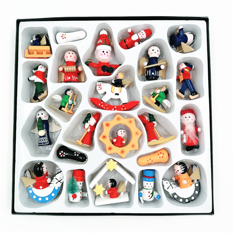 A collection of colorful, miniature wooden Christmas ornaments in a variety of shapes, including Santas, angels, snowmen, and rocking horses, neatly arranged in a white box.