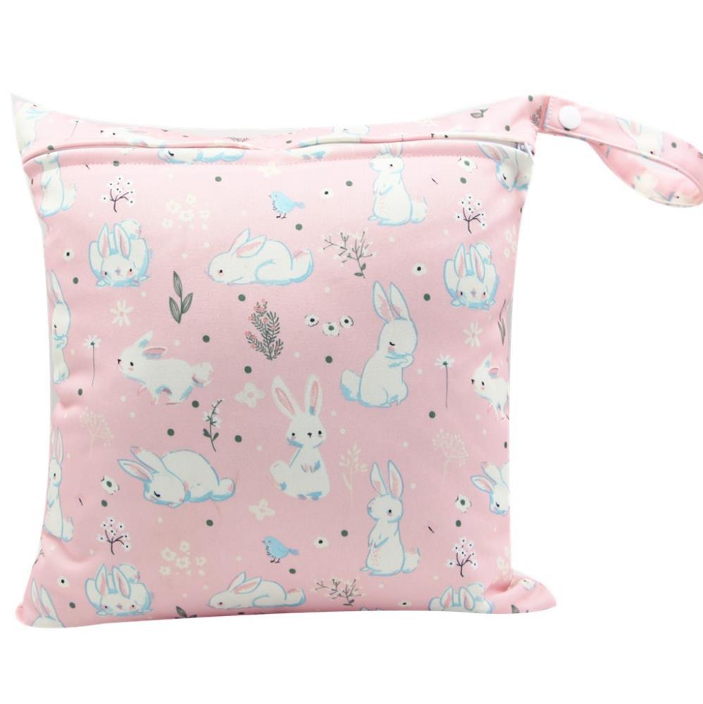 Pink bag with a cute pattern of white bunnies, flowers, and small blue birds. The bag features a snap closure and a wrist strap for easy carrying.